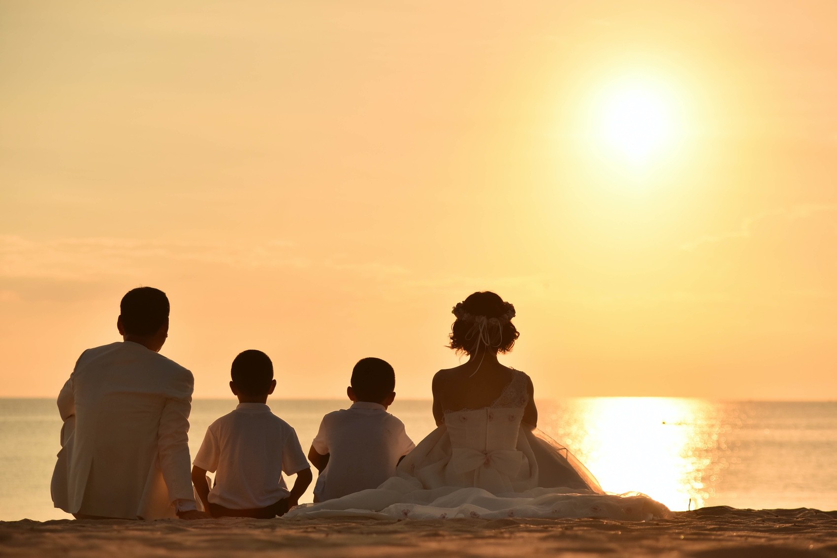 海を眺める家族みんなの背中